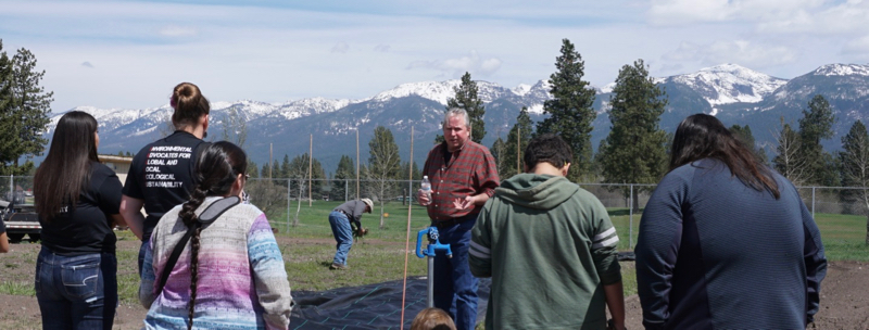 Virgil Dupuis, Extension Director for Salish Kootenai College, speaks with high school students in the college garden at NWAL Youth Day. May 3, 2018.