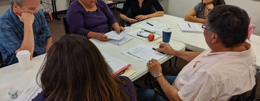 Educators sitting at table at Teaching Native Waters workshop